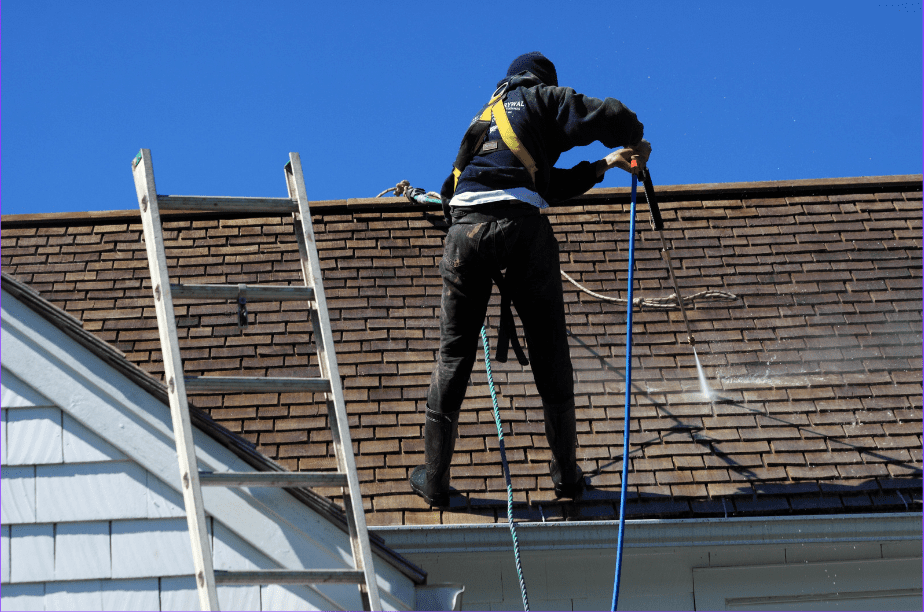 Worker cleaning roof